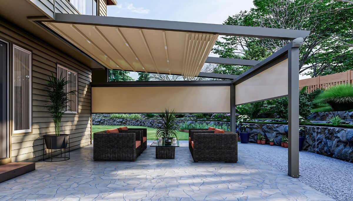 Pergomatic aluminum pergola with partially retracted PVC roof and drop-down screens shading wicker lounge on stone patio.